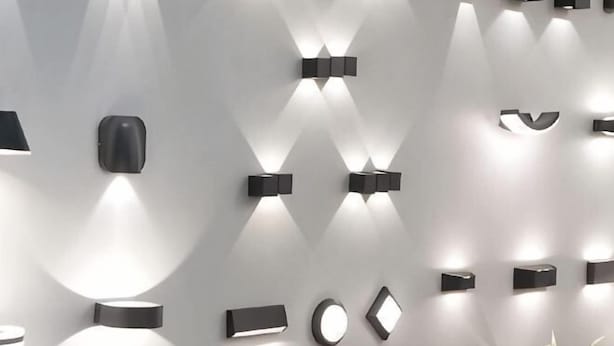 A wall with variously shaped wall-mounted lights. - Erykah Hotel Mityana Road (Mawokota)
