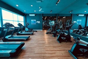 A gym with treadmills, elliptical machines, and weight equipment. - Johor Cozy Home 2 Rooms & Easy Parking Fast WiFi ! (Plentong)