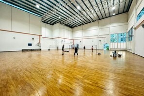 A spacious indoor gym with a wooden floor, high ceilings, and large windows. - Johor Cozy Home 2 Rooms & Easy Parking Fast WiFi ! (Plentong)