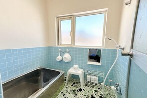 A bathroom with a bathtub, a window, and a shower. - Mintmint (Noboribetsu)