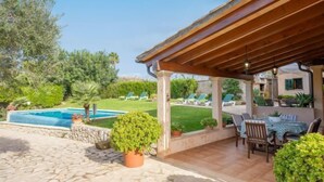 A covered outdoor patio with a pool, stone flooring, and potted plants. - REYNES - Rustic villa with private pool and free Wi-Fi (Pollensa)