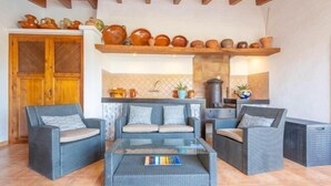 A cozy outdoor seating area with wicker furniture and a glass-top coffee table. - REYNES - Rustic villa with private pool and free Wi-Fi (Pollensa)