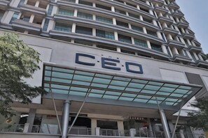 A modern building with a large 'CEO' sign on the facade, indicating it might be a corporate headquarters. - 3-Bed Exec Suite RumahKu Airport Penang (Bayan Lepas)