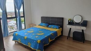 A bedroom with a bed, a bedside table, a mirror, and a view of the city through large windows. - LittleChing @ Armadale Residence Galacity (Kuching)