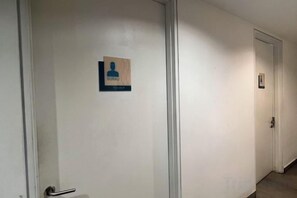A hallway with doors, each marked with a nameplate. - Setia sky 88 Foo homestay (Johor Bahru)