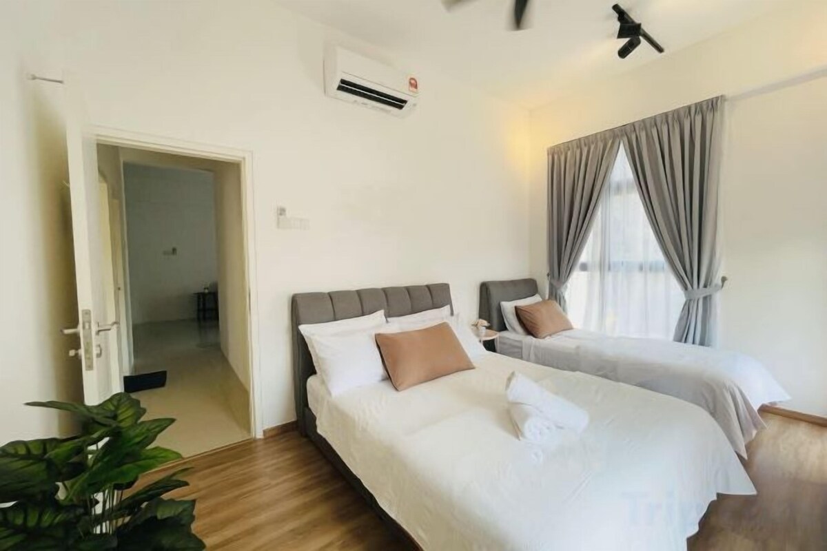 A hotel room with two beds, a ceiling fan, an air conditioning unit, and a large window with curtains.