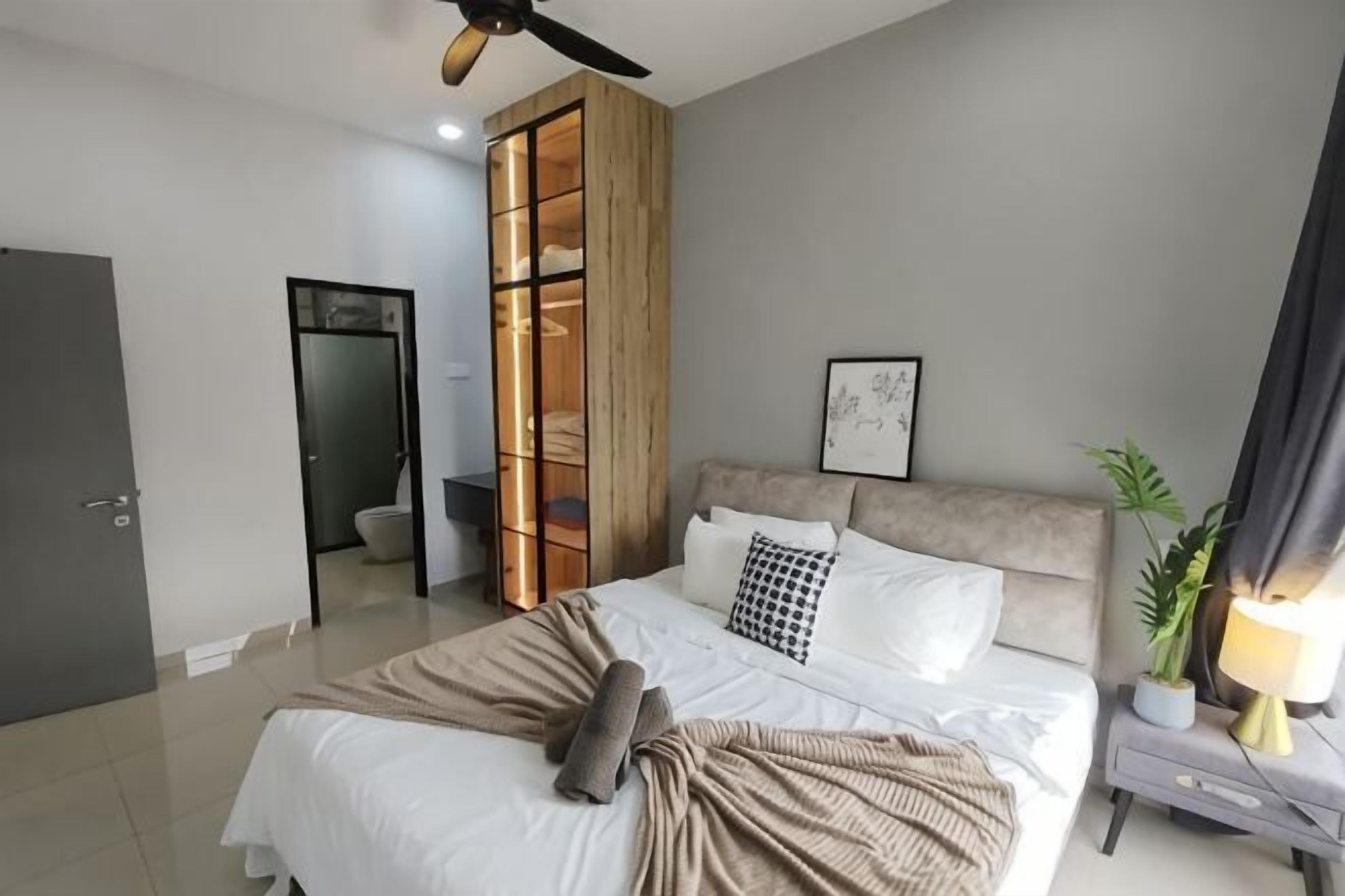 A bedroom with a bed, bedside table, and a wardrobe.