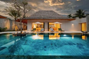 A modern villa with a swimming pool, outdoor seating, and a view of the sky. - Anchan Tropicana Pool Villa near Laguna & Beach Phuket Warm Plus (Phuket)