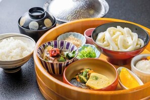 A traditional Japanese meal with various dishes on a tray.