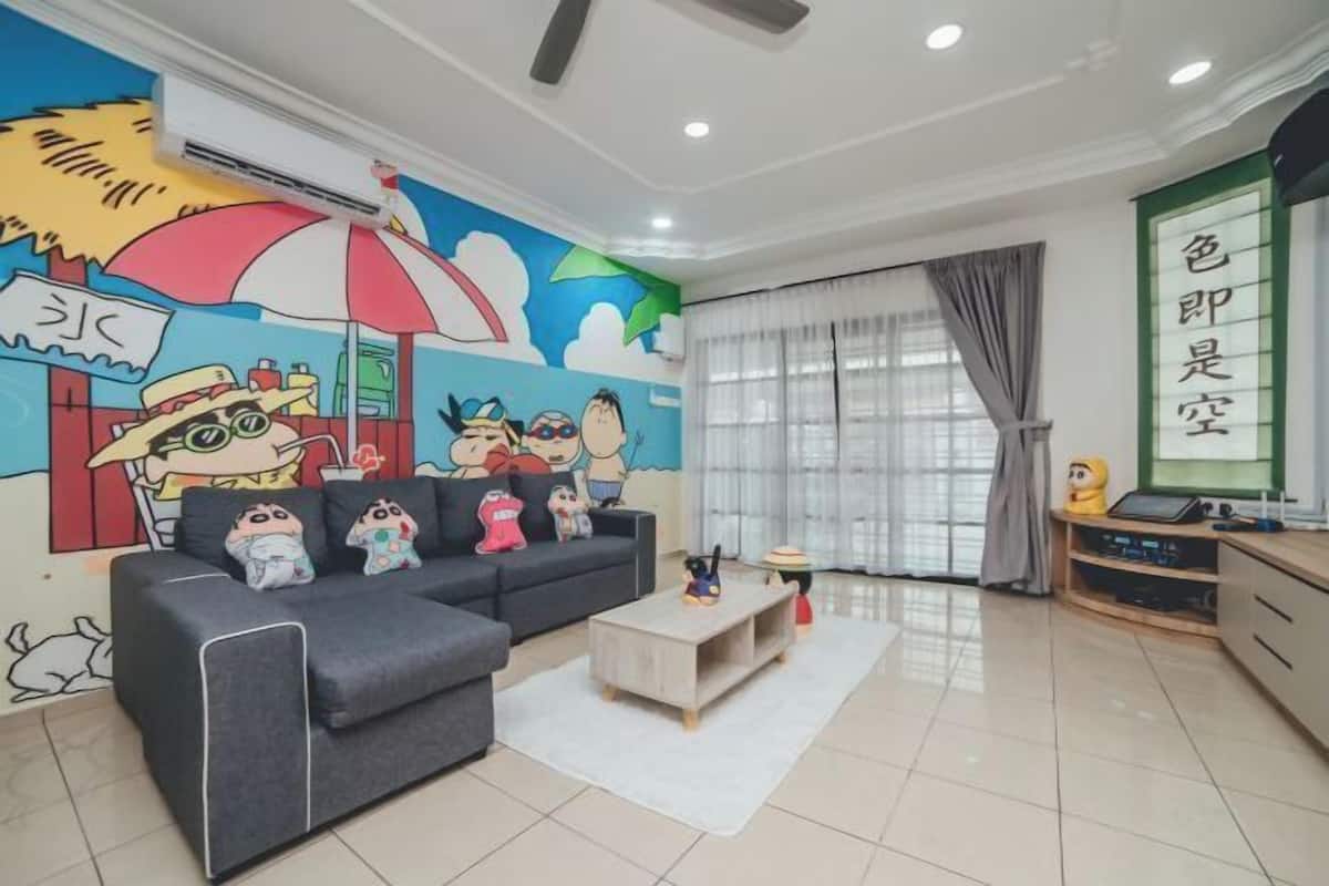 A living room with a sofa, a coffee table, a mural, and a window with curtains.