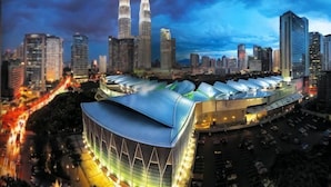 A modern building with a large, curved roof and multiple parking spaces. - Central 2BR Apt 5 mins to KLCC Twin Towers (Kuala Lumpur)