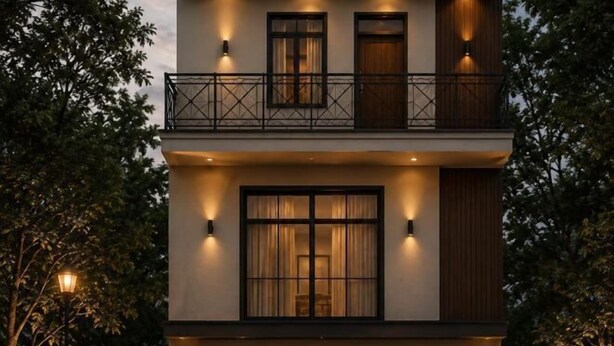 A multi-story building with balconies and exterior lighting.