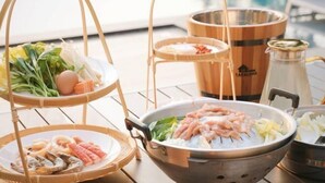 A hot pot setup with various ingredients and a wooden barrel. - KIN Pool Villa Khaoyai (Pak Chong)