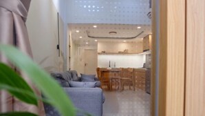 A compact living space with a sofa, dining table, and kitchen area. - Central, Near Airport, Dragon Bridge - Gau's House (Da Nang)