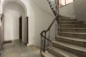 A staircase with a metal handrail leading to an upper floor. - Ganbaru Tours - Flats in Galata (Istanbul)