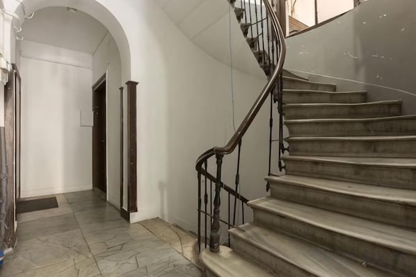 A staircase with a metal handrail leading to an upper floor. - Ganbaru Tours - Flats in Galata (Istanbul)