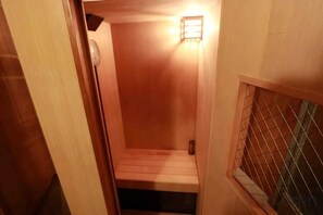 Un interior de fusta amb una banca i un petit lluminari.