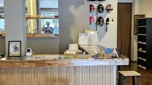 A bar area with stools, a counter, and various items on display. - KT8 Hotel Aonang (Krabi)