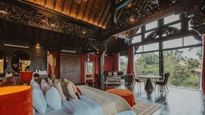 A spacious bedroom with a large bed, a sitting area with a table and chairs, and a view of the outdoors. - Villa Cella Bella ( Bali instaworthy villa ) (Bali)