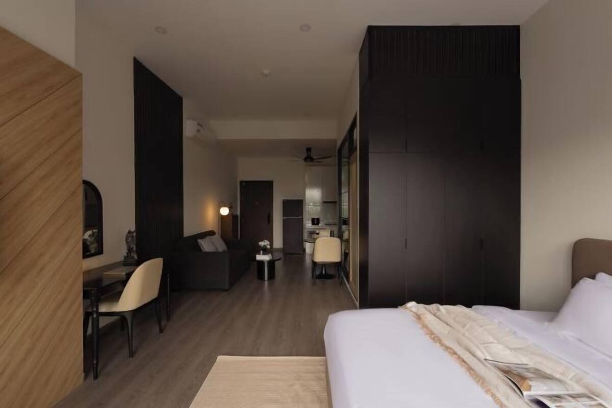 Une chambre d’hôtel moderne équipée d’un lit, d’un bureau et d’un coin salon.
