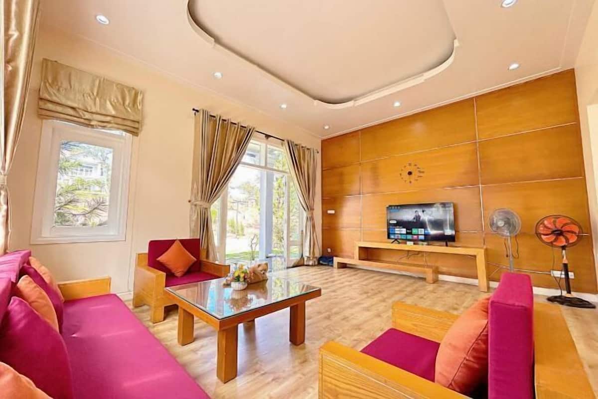 A modern living room with a sofa, a coffee table, and a TV.