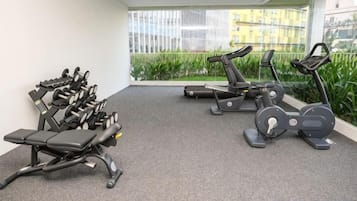 A gym with stationary bikes, treadmills, and weight machines.
