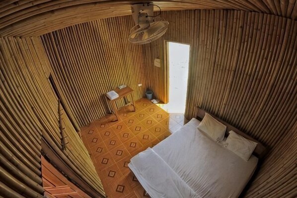 A room with a bed, a small table, and a chair. - Ethnic Guesthouse (Luang Namtha)