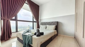 A bedroom with a bed, curtains, and a view of the city. - 3806 Macrolink 6pax Cozy Legoland Netflix BySTAY (Iskandar Puteri)