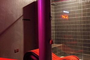 A room with a shower area, a door, and a visible light switch. - Clan Living - the Lovers Ubud Private Villas (Bali)