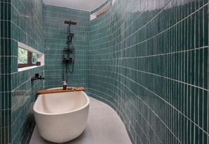 A modern bathroom with a freestanding bathtub, a shower, and a window. - Clan Living - the Lovers Ubud Private Villas (Bali)