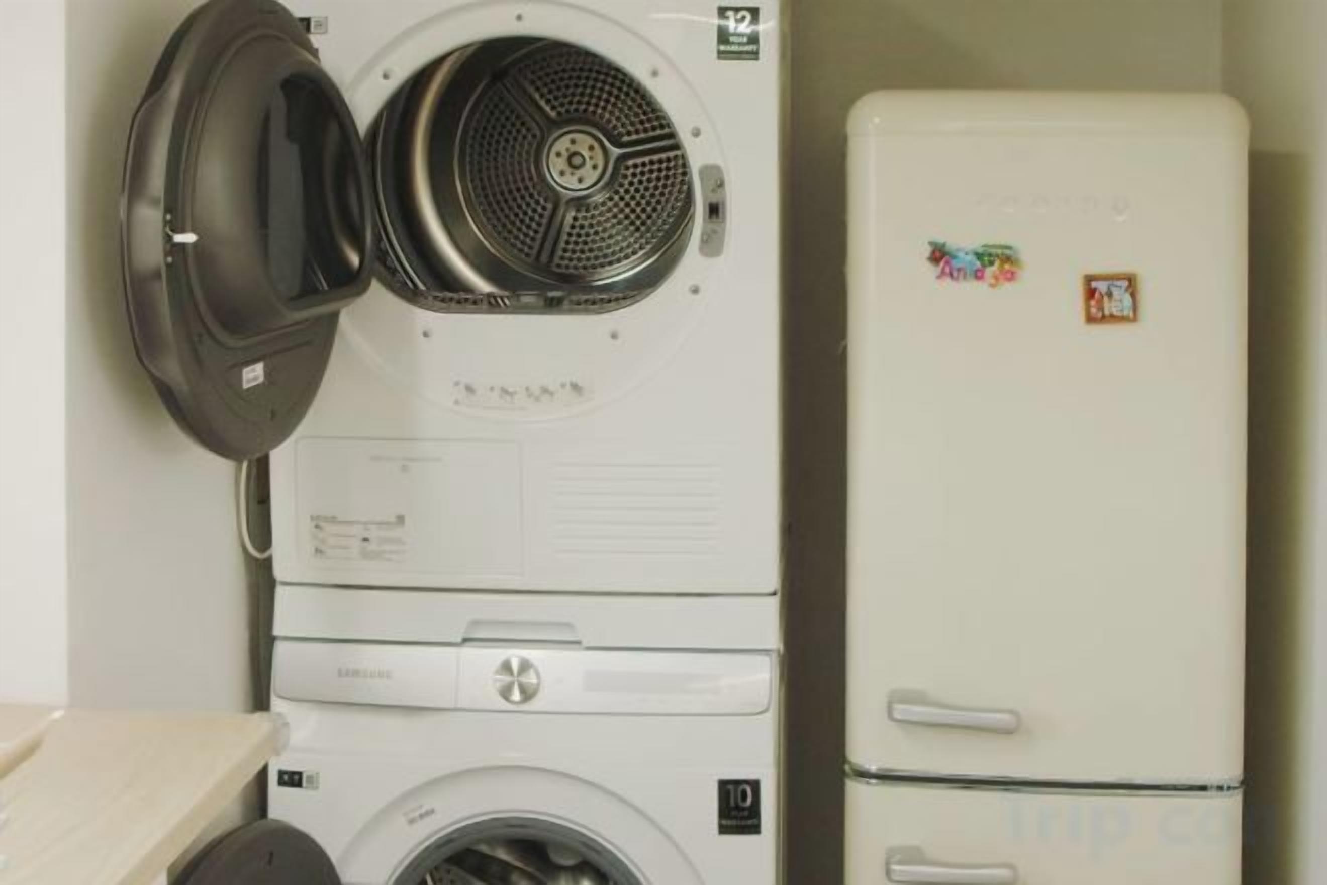 A compact appliance unit with a dryer, washing machine, and refrigerator.