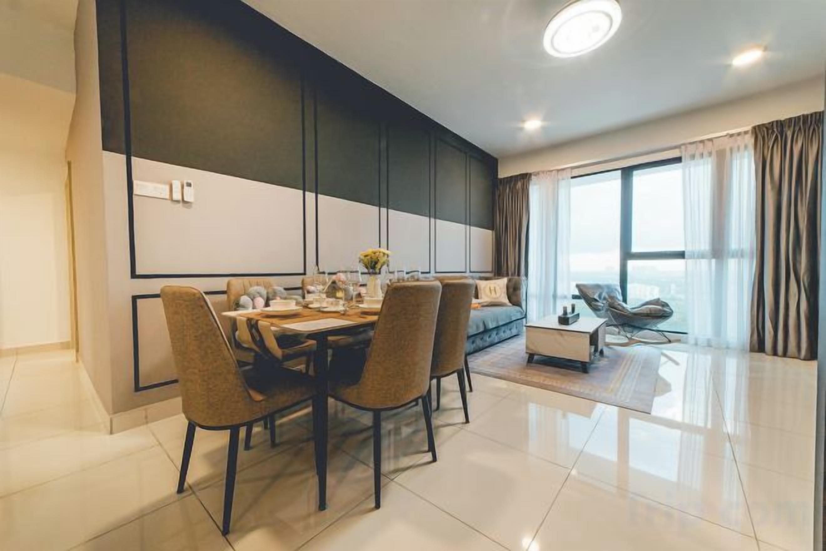 A modern dining area with a table set for four, a sofa, and a view of the outdoors.