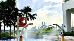 A water play area with a cityscape view.