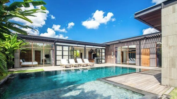 A modern house with a swimming pool, large windows, and a deck area. - Bodhisatva (Bali)