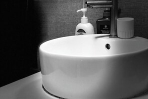 A round white sink with a faucet and a soap dispenser. - Hoang Gia Hotel (Tan Uyen District)