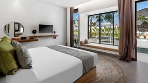 A modern bedroom with a large bed, a TV mounted on the wall, and a view of a pool and palm trees through large windows. - Villa Nature View by BaliSuperHost (Bali)