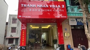 A building with a red and yellow facade, labeled "THANH NHAN VILLA 2". - Qing Xian Homestay (Bac Ninh)