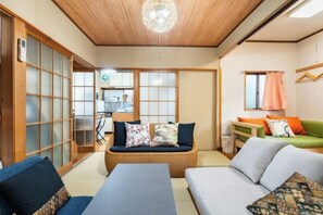 A traditional Japanese-style room with tatami flooring, a low wooden ceiling, and sliding doors. - Yotsugi2 House (Tokyo)