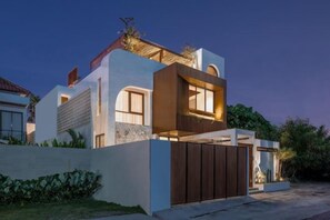 A modern two-story house with a gated entrance, a sloped roof, and a well-maintained garden. - Fenta Villa Canggu by Nakula (Bali)