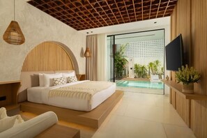 A modern bedroom with a large bed, a TV, and a view of a pool. - Fenta Villa Canggu by Nakula (Bali)
