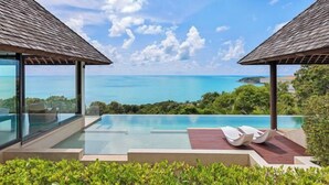A luxurious pool area with clear blue water, surrounded by lush greenery and overlooking a scenic ocean view. - Jasmine Waterslide 5BR Pool Villa (Koh Samui)