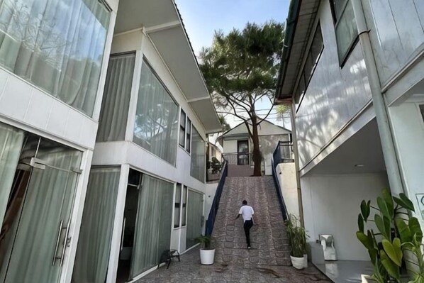 Um edifício moderno com uma escadaria que leva a uma varanda no segundo andar.