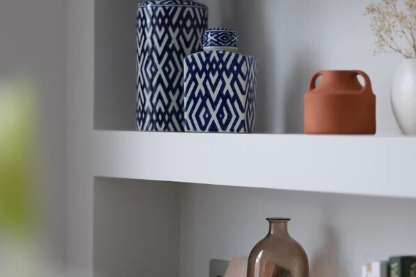 A shelf with decorative vases and a vase. - 317 Grand Maisonette (London)