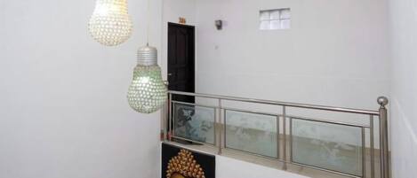 A staircase with a metal railing and a door at the top.