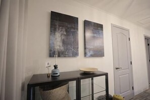 A hallway with a black console table, a bowl, and two abstract paintings on the wall. - [TV] Luxury adult secret base villa 120 ㎡ Sauna, stone bath, bonfire, BBQ [Zen Building] (Miyota)