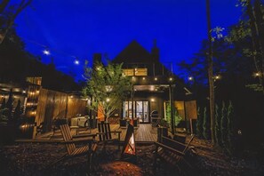 A modern house with a patio area featuring outdoor furniture and a fire pit. - [TV] Luxury adult secret base villa 120 ㎡ Sauna, stone bath, bonfire, BBQ [Zen Building] (Miyota)