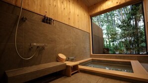 A wooden interior with a bathtub, a shower, and a window with a view of trees. - [TV] Luxury adult secret base villa 120 ㎡ Sauna, stone bath, bonfire, BBQ [Zen Building] (Miyota)