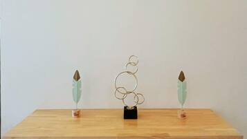 A wooden table with a metal sculpture in the center.