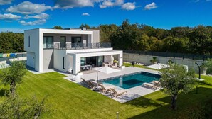 A modern two-story house with a swimming pool, outdoor seating, and a well-maintained lawn. - Villa Sever by Villas Guide (Svetvincenat)