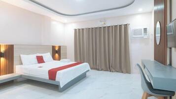 Una habitación de hotel moderna con cama, escritorio y televisión.
